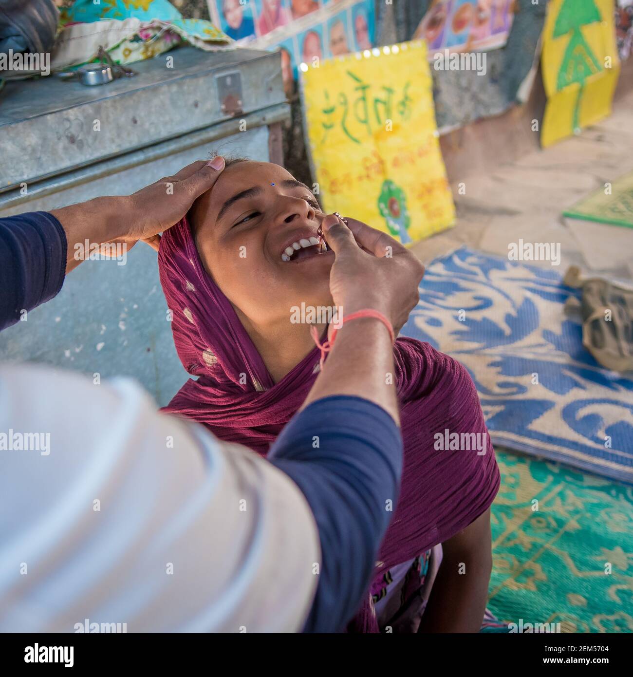 Rajasthan. India. 07-02-2018. A girl in a village of the Rajasthan is receiving medical attention by a doctor receiving medication. Stock Photo
