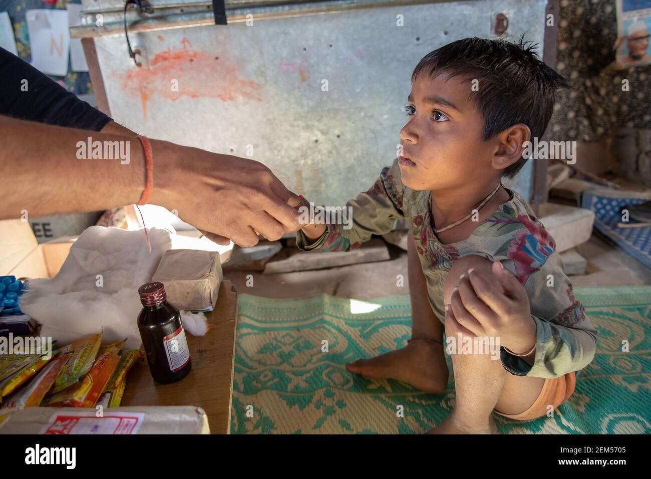 ajasthan. India. 07-02-2018. A boy in a village of the Rajasthan is receiving medical attention by a doctor receiving medication. Stock Photo