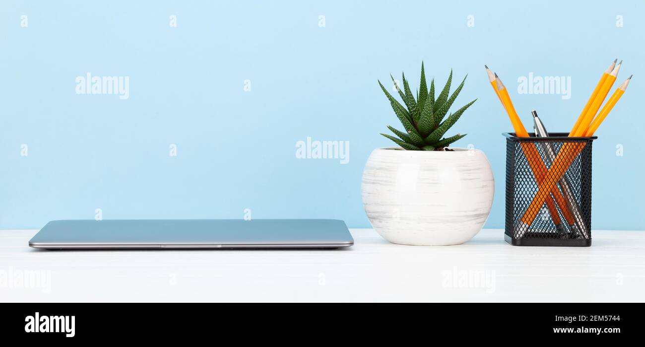 Studio workspace with laptop computer and office supplies. Work from