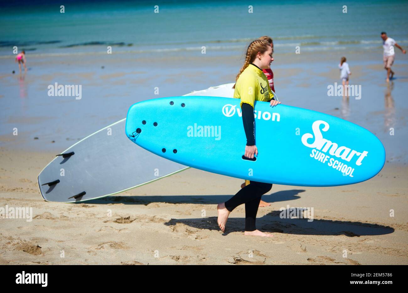 Woman having a surfing lesson at Sennen Cove in Cornwall during summer Stock Photo