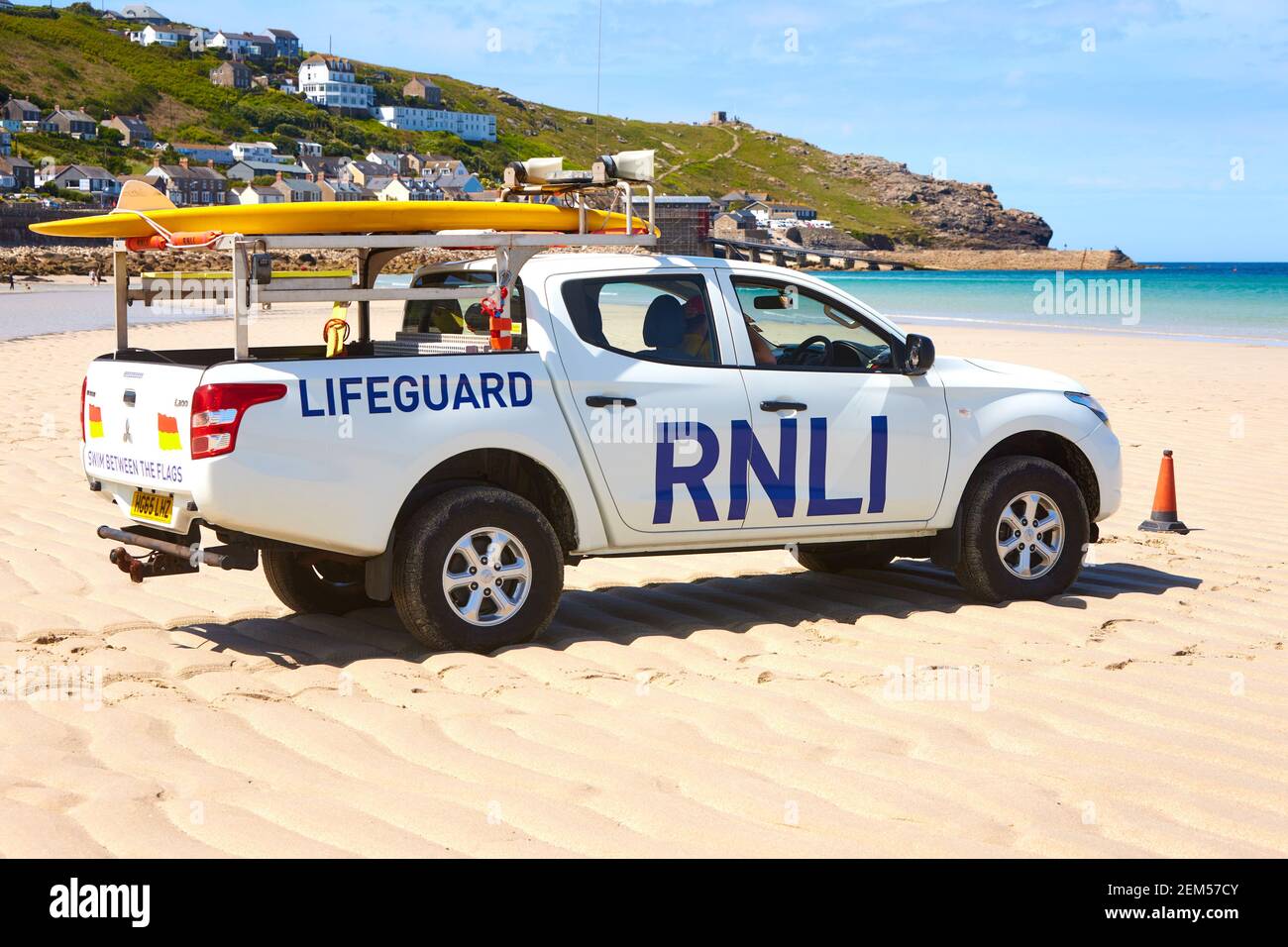 RNLI lifeguard on Sennen Cove beach in Cornwall during summer Stock Photo