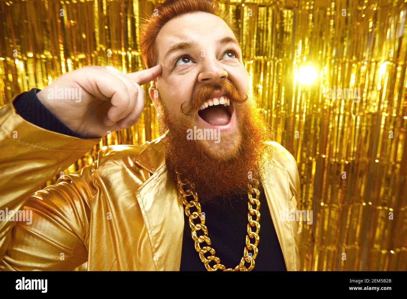 Excited bearded man in extravagant outfit with gold chain necklace having fun at a party Stock Photo