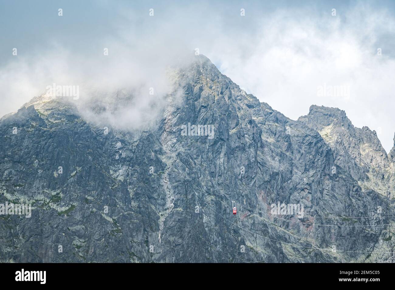 View of the Lomnicky stit peak, famous rocky summit in High Tatras, Slovakia. Cloudy windy day. Stock Photo