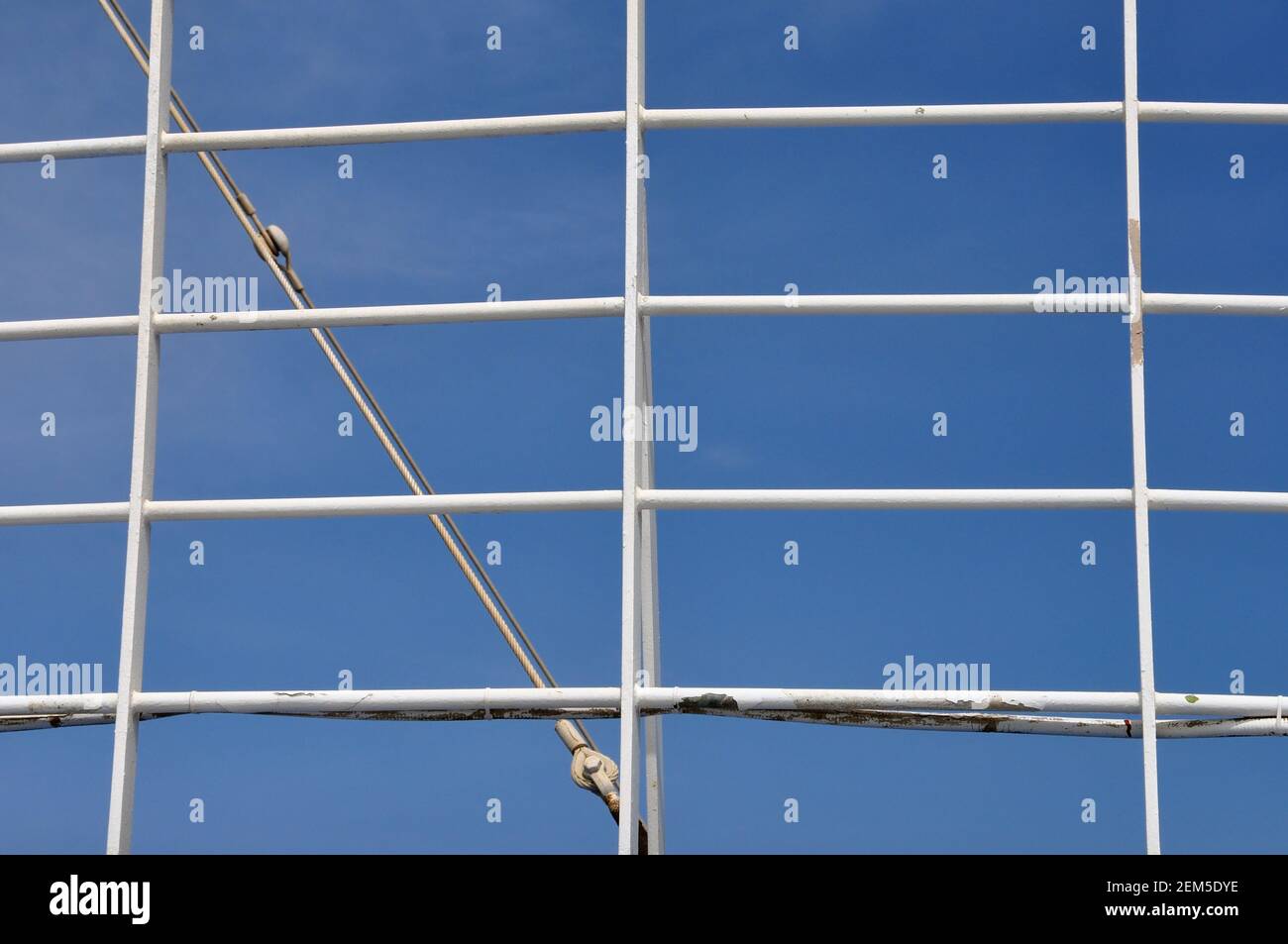 White railing and blue sky background. Iron handrail on ferry boat ...