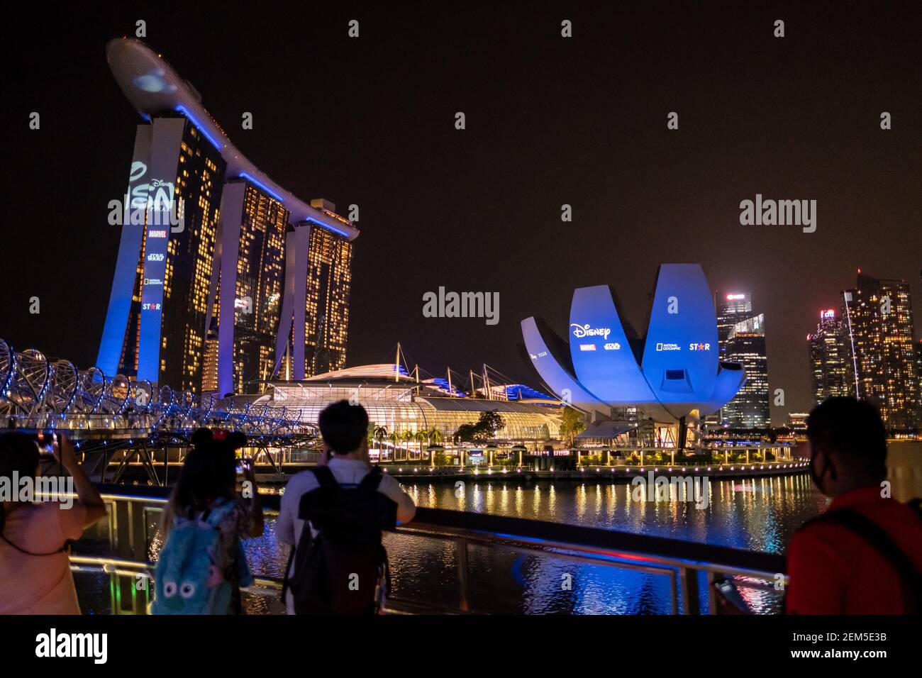 People Are Seen Watching Disney Showcase That Was Projected At The Singapore Art Science Museum And The Marina Bay Sands Singapore Disney Was Launched In Singapore On The 24th February 21 Making The