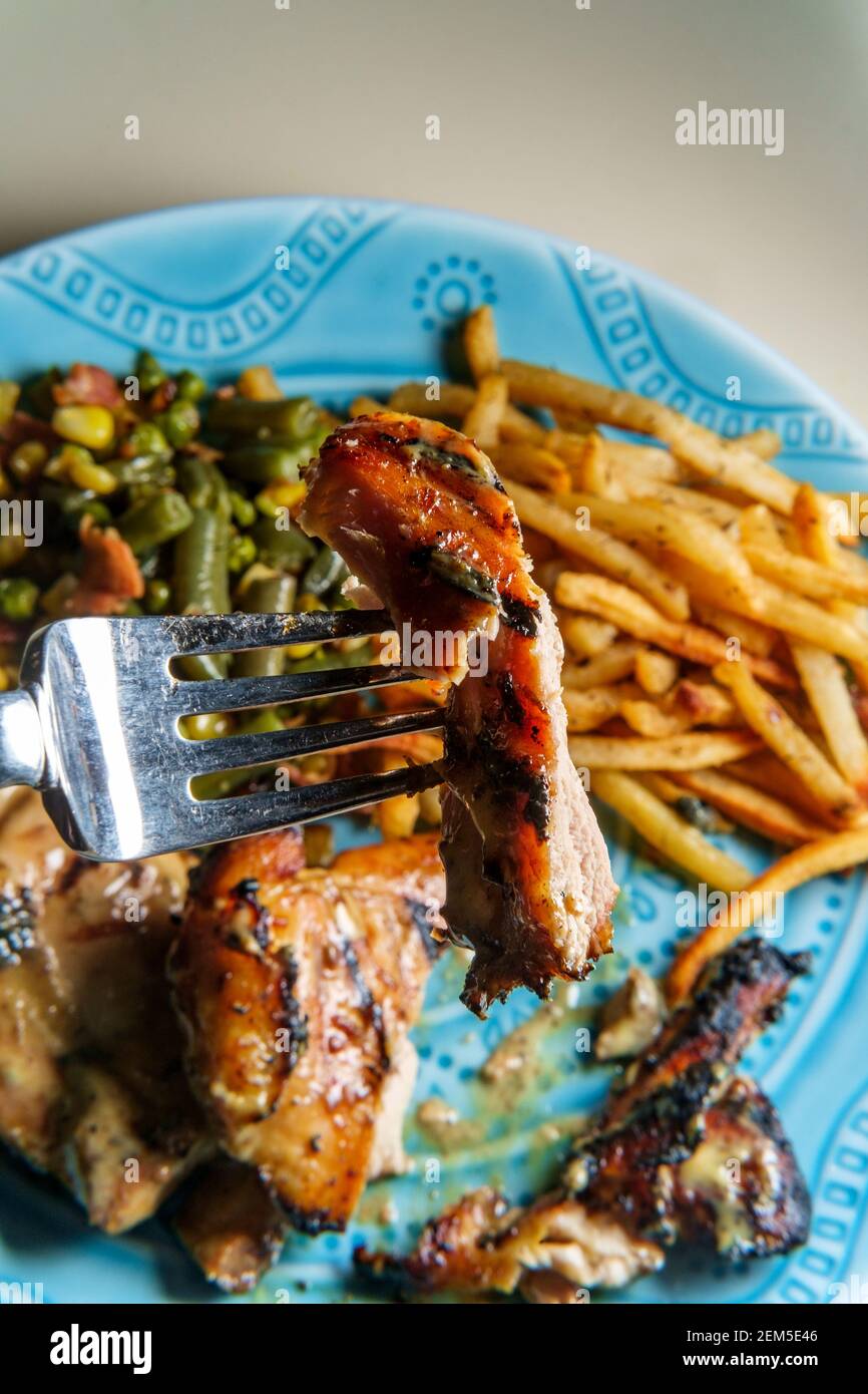 Honey mustard grilled chicken thigh dinner served with homemade shoestring French fries and