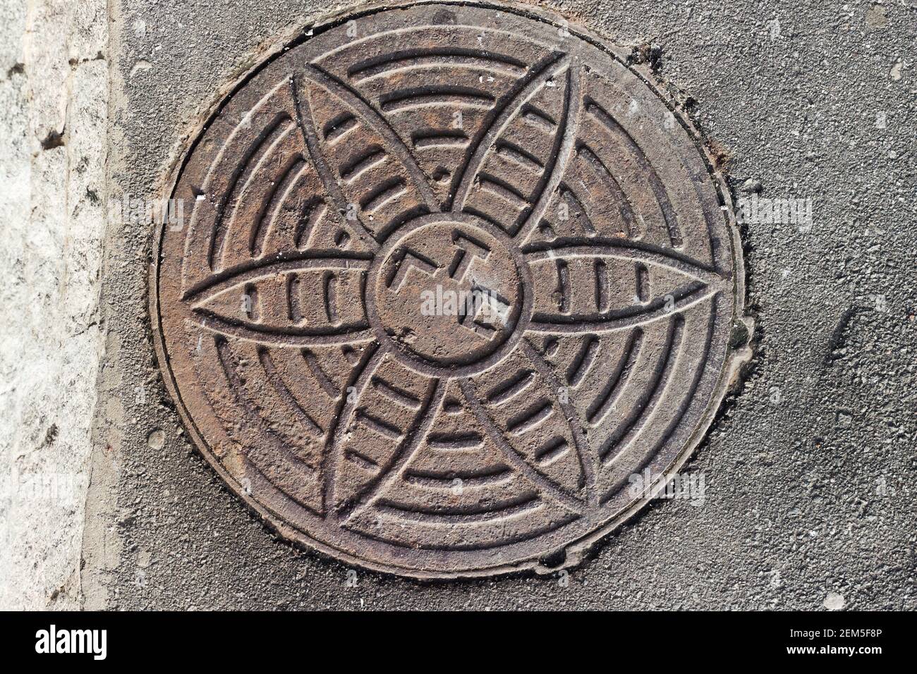 Cast iron manhole cover to city telephone network Stock Photo