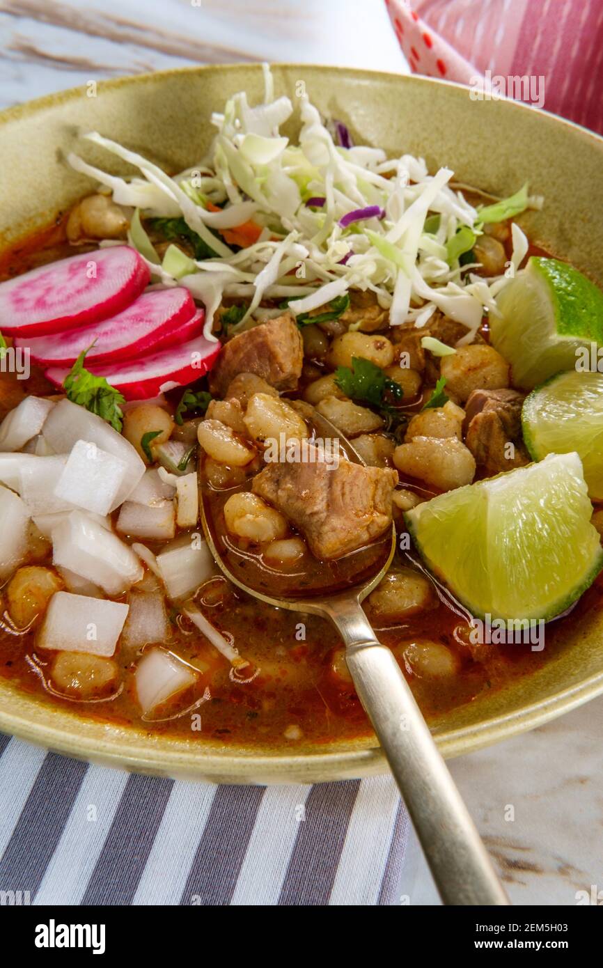 Mexican Pozole rojo pork and hominy stew with variety of fresh