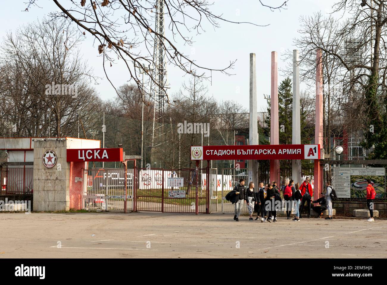 Young footballers leaving the CSKA Sofia Bulgarian Army stadium main entrance gate in downtown Sofia, Bulgaria, Eastern Europe, EU as of February 2021 Stock Photo