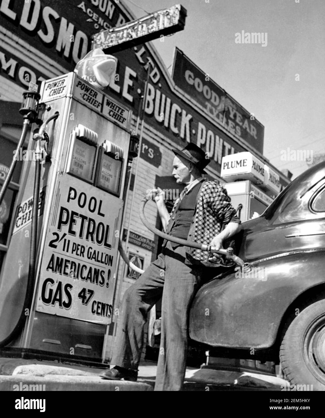 PETROL DOWN UNDER An enterprising garage owner in Drouin, Victoria, Australia, in 1944 displays his pricing in US currency. Stock Photo