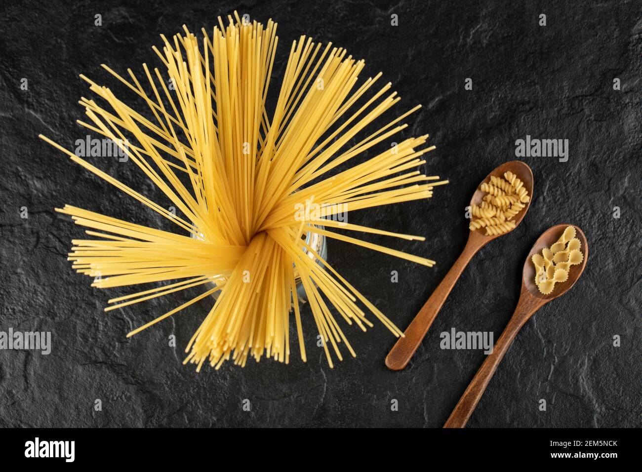 Three types of uncooked pasta on a black background Stock Photo