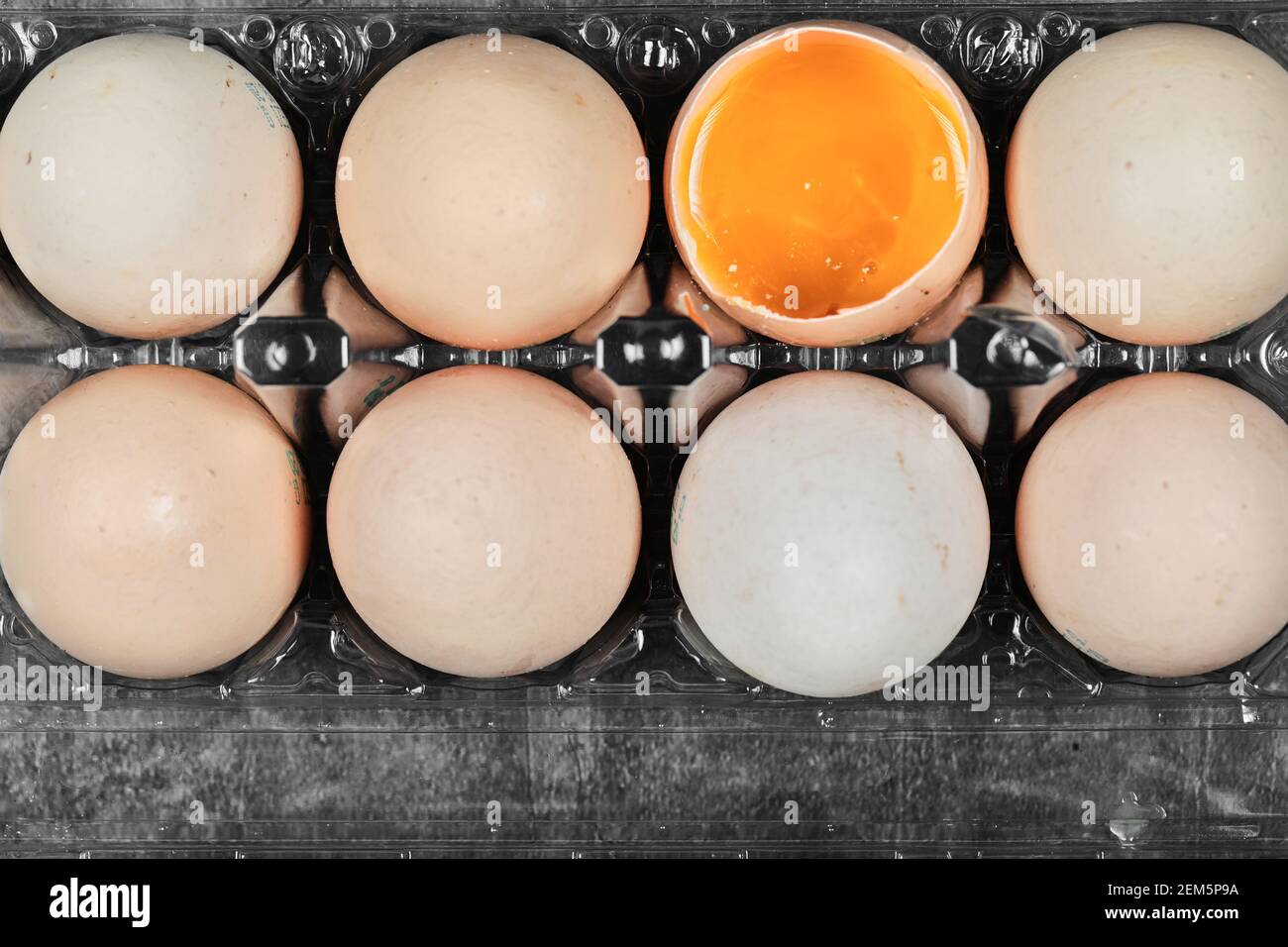 Flat lay closeup view raw and soft boiled eggs on plastic box Stock Photo