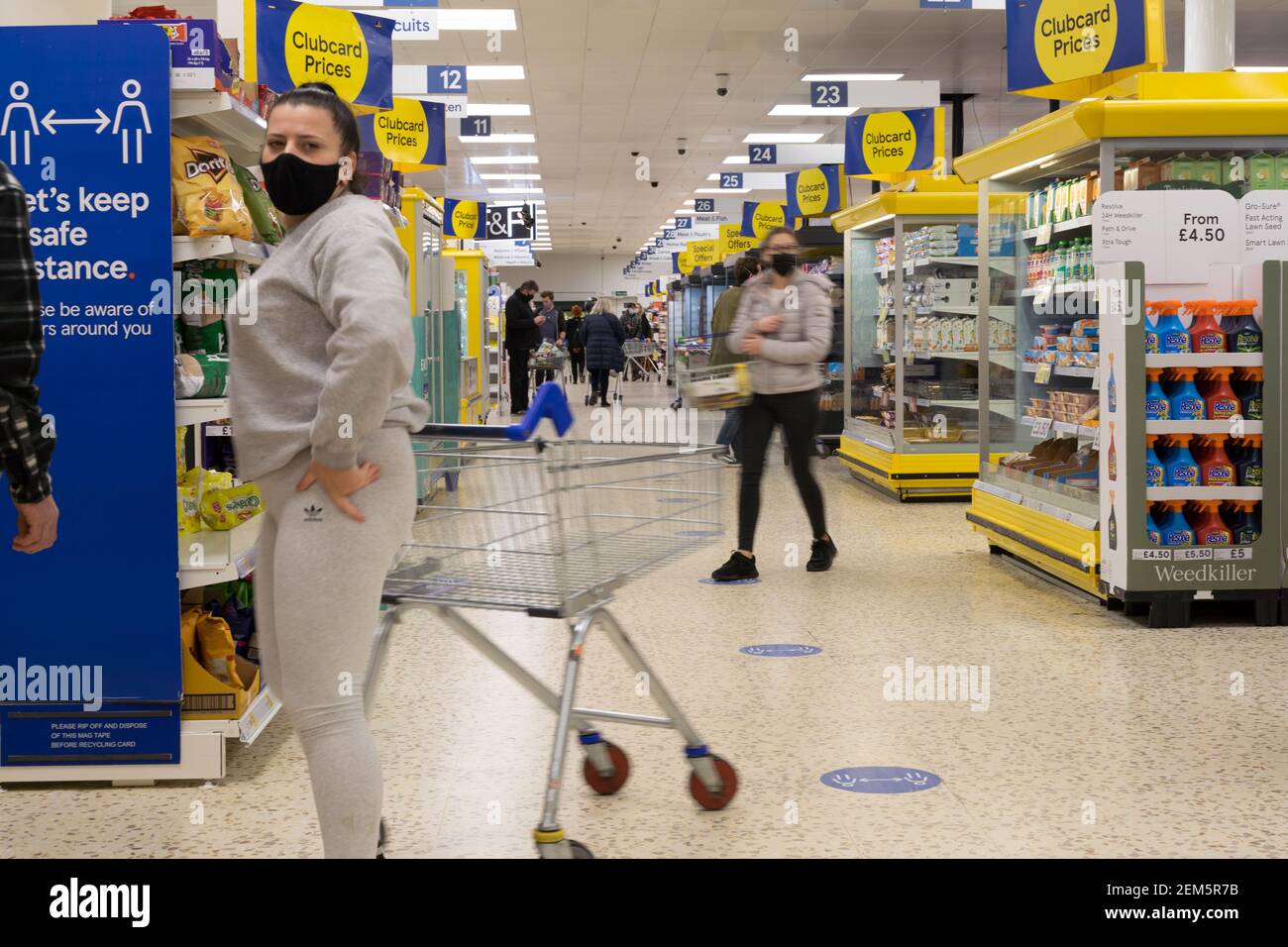 Shoppers in face mask shopping at supermarket Tesco superstore, London