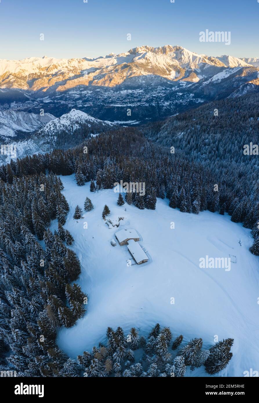 Aerial view of the Valmezzana hut and Presolana massif during a winter sunrise from Monte Pora, Val Seriana, Bergamo district, Lombardy, Italy. Stock Photo