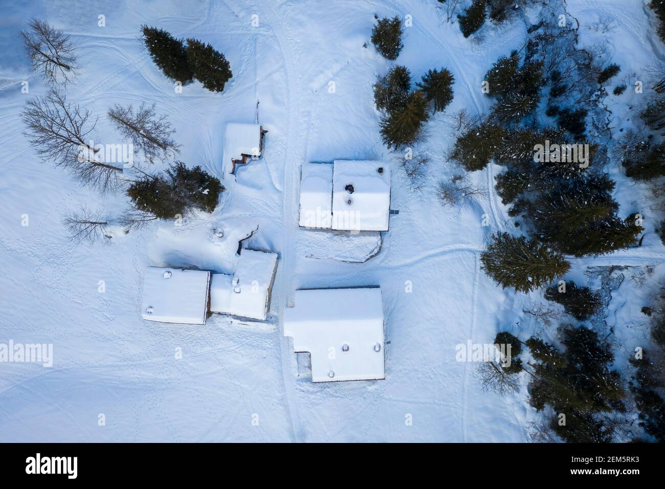Aerial view of Baite del Moschel in winter covered in snow. Oltressenda Alta, Valzurio, Val Seriana, Bergamo district, Lombardy, Italy. Stock Photo