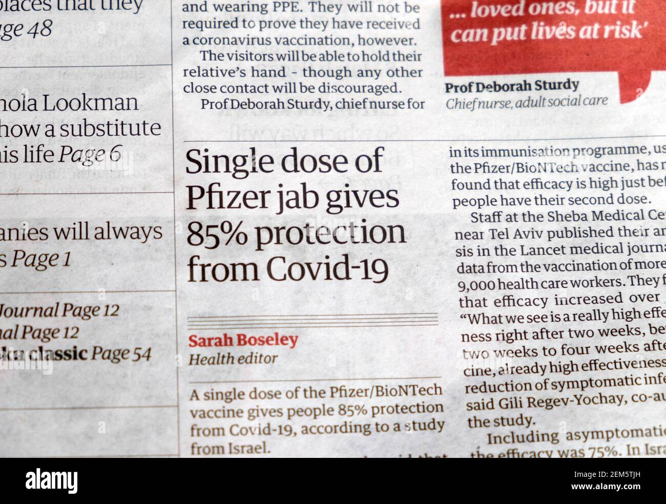 "Single dose of Pfizer jab gives 85% protection from Covid-19" Guardian newspaper headline on Covid article inside page 20 February 2021 London UK Stock Photo