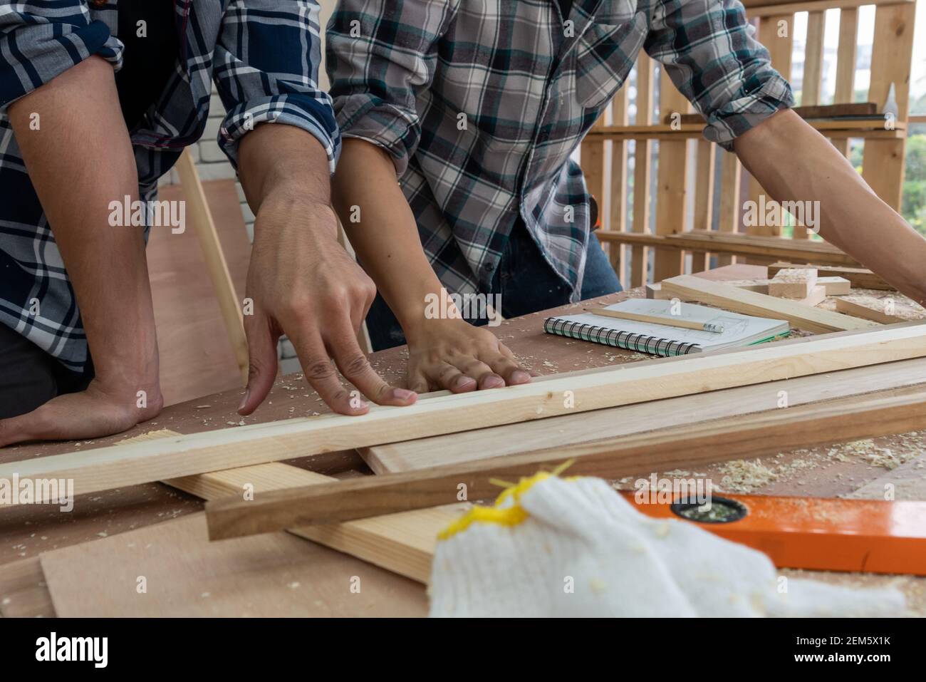Carpenter working on wood craft at to produce construction