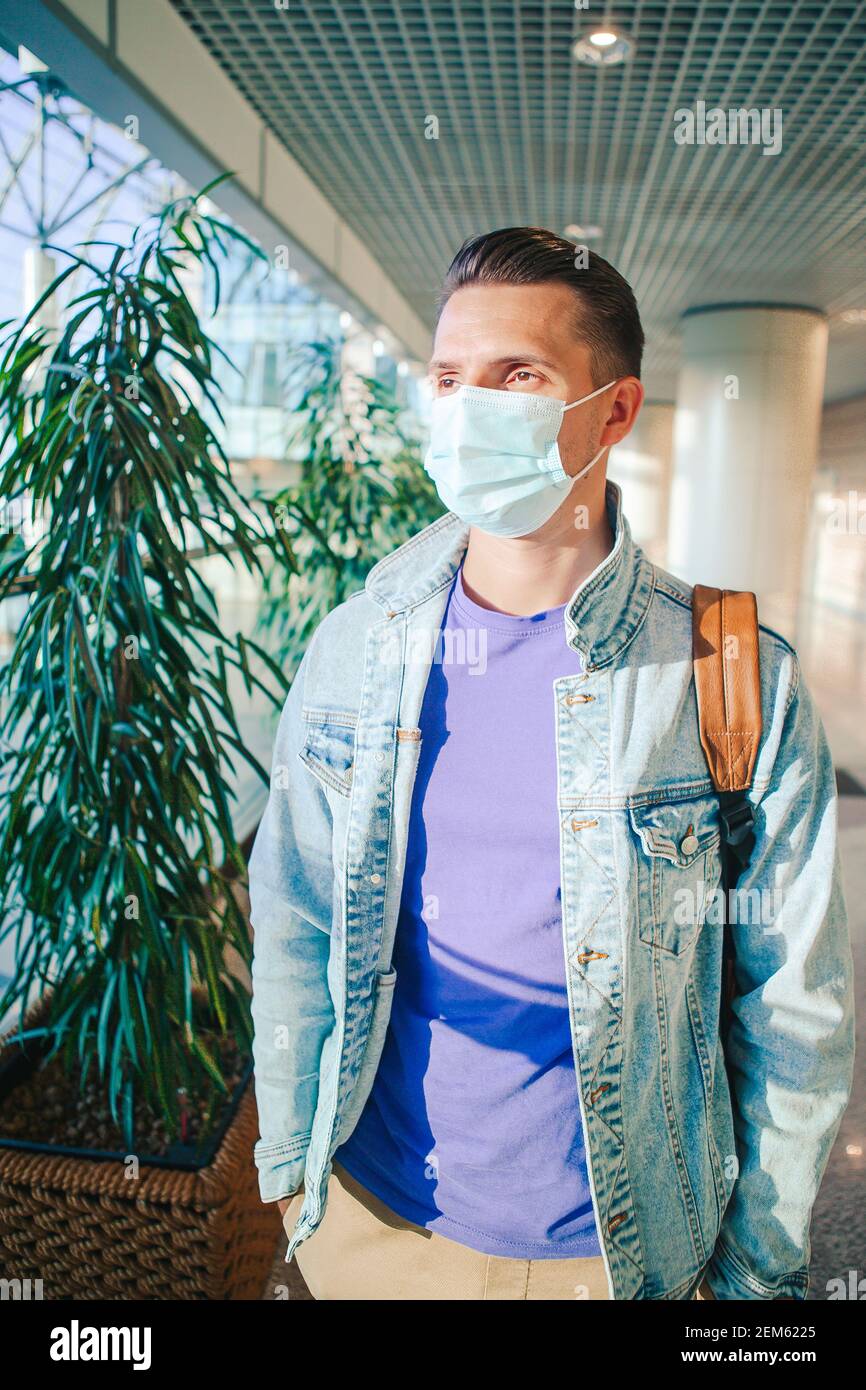 Man wearing a mask for prevent virus in international airport lounge
