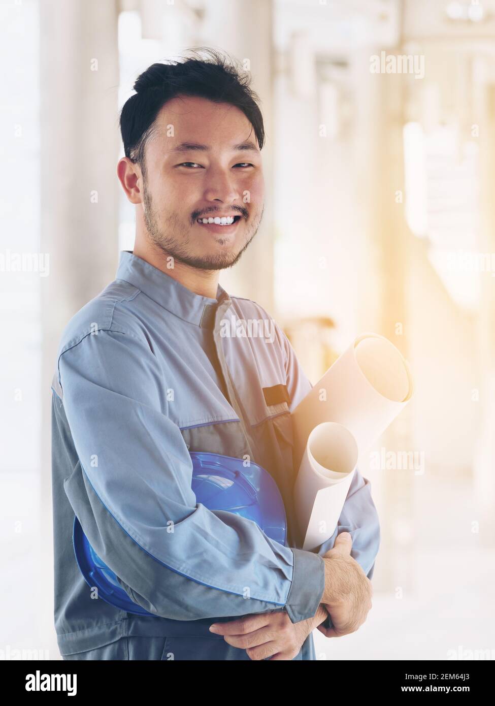 Portrait of happy engineer. East Asian ; Japanese, Chinese, Korean engineer looking at camera, smile. Engineering people concept. Stock Photo