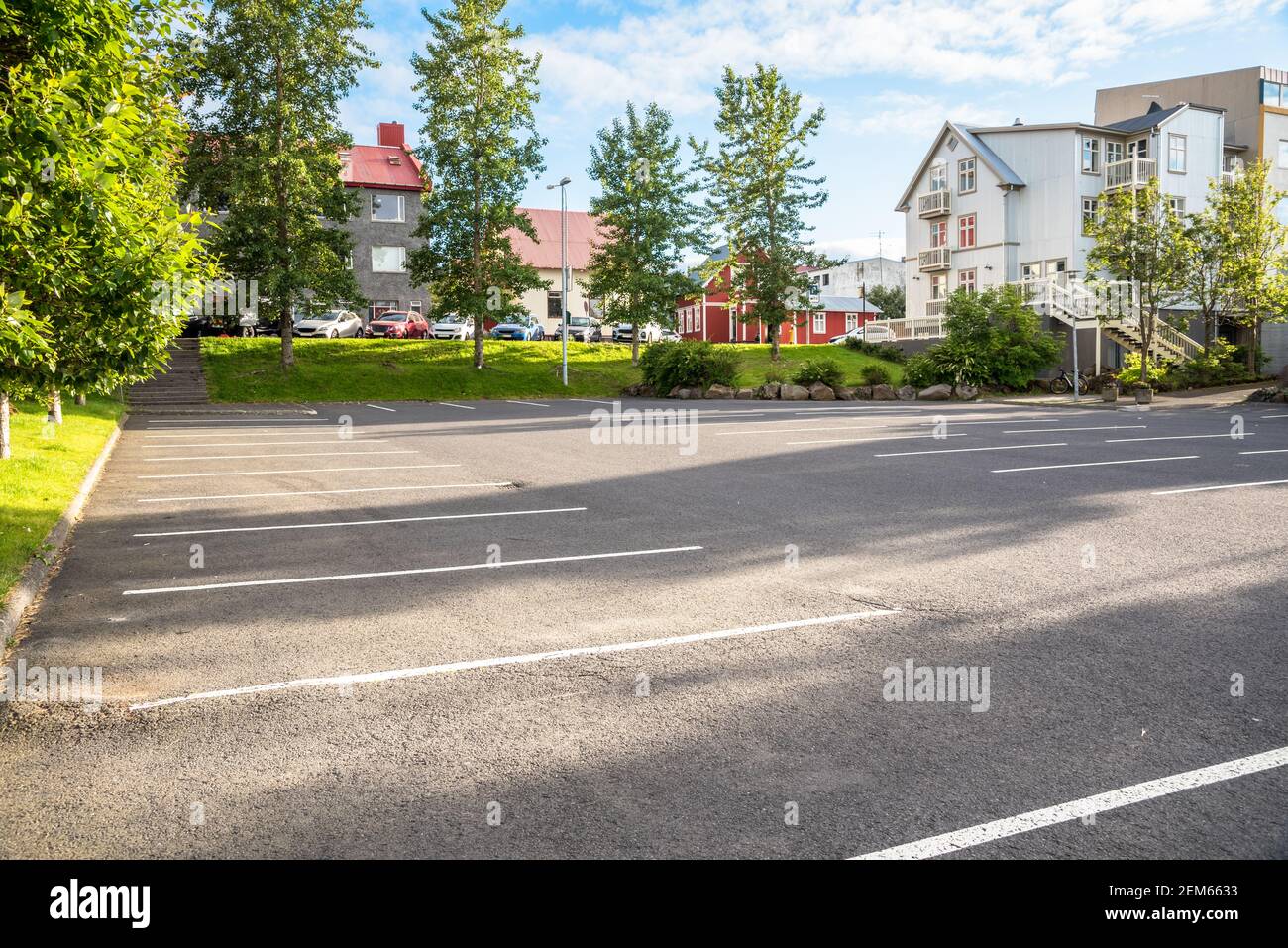 Deserted parking lot in a residentail district on a sunny summer evening Stock Photo