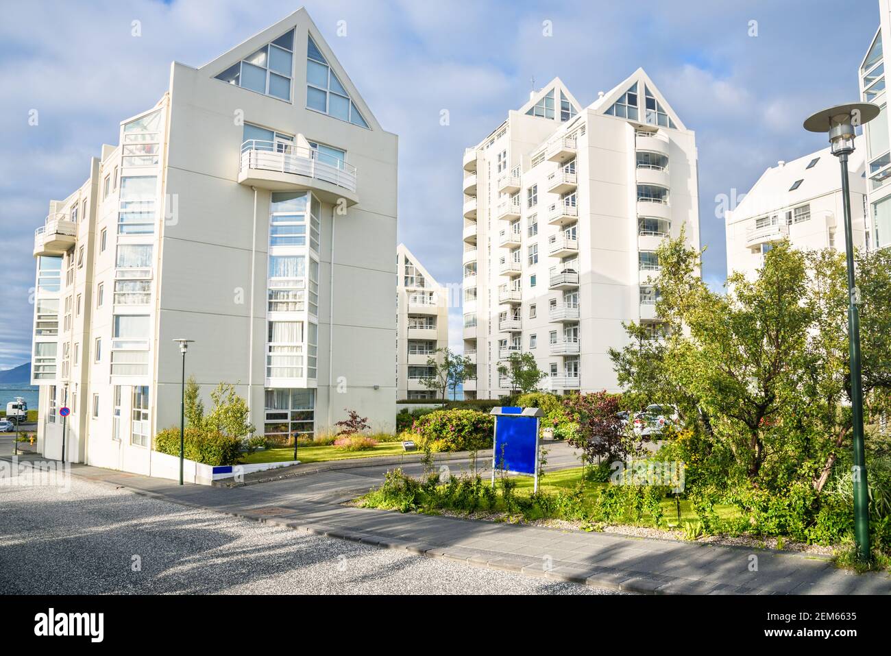 Modern high rise apartment buildings with a private communal garden on a sunny summer day. Reykjavik, Iceland. Stock Photo