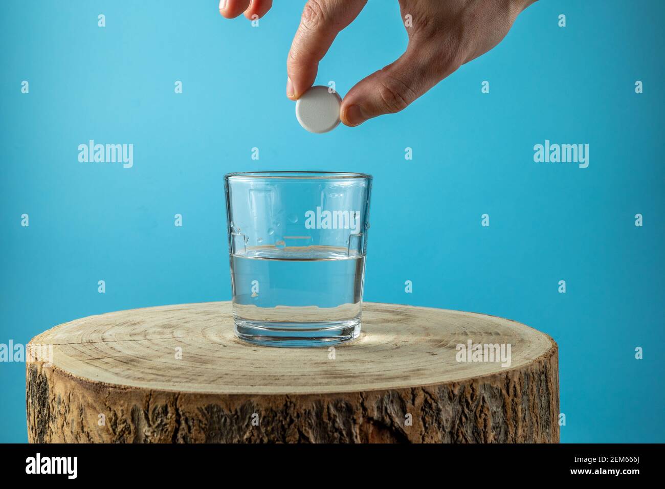 Putting effervescent pill into glass full of water Stock Photo
