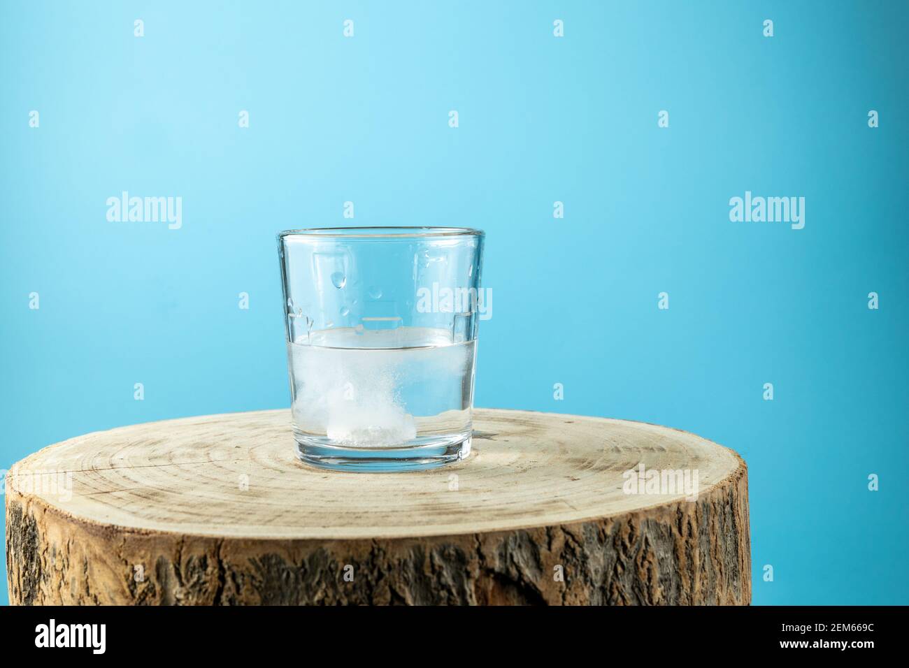 Putting effervescent pill into glass full of water Stock Photo