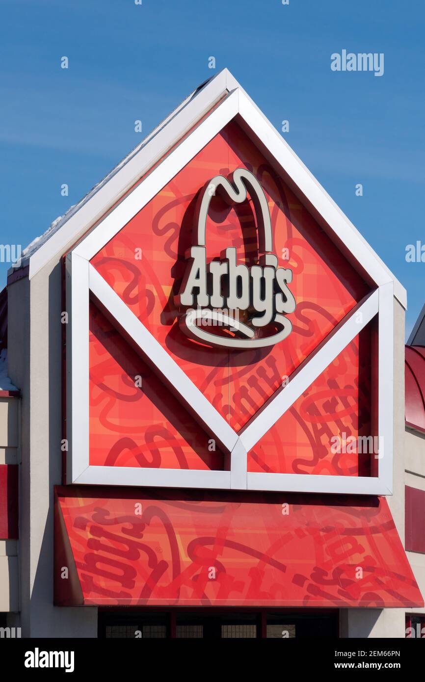 MAPLEWOOD, MN, USA - FEBRUARY 20, 2021: Arby's fast food restaurant exterior and trademark logo. Stock Photo