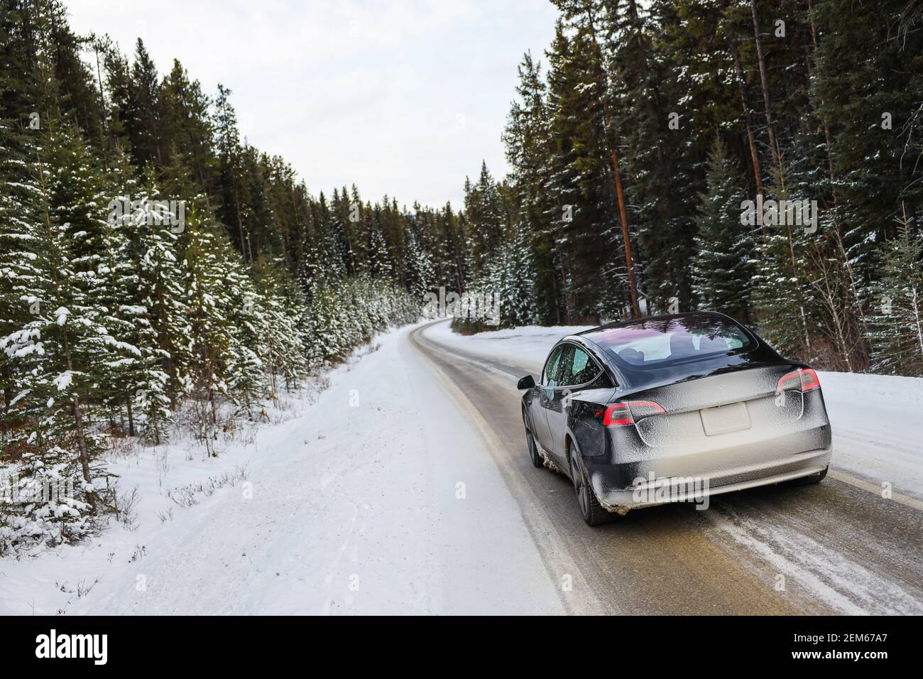 Electric car driving, mountains snow Stock Photo