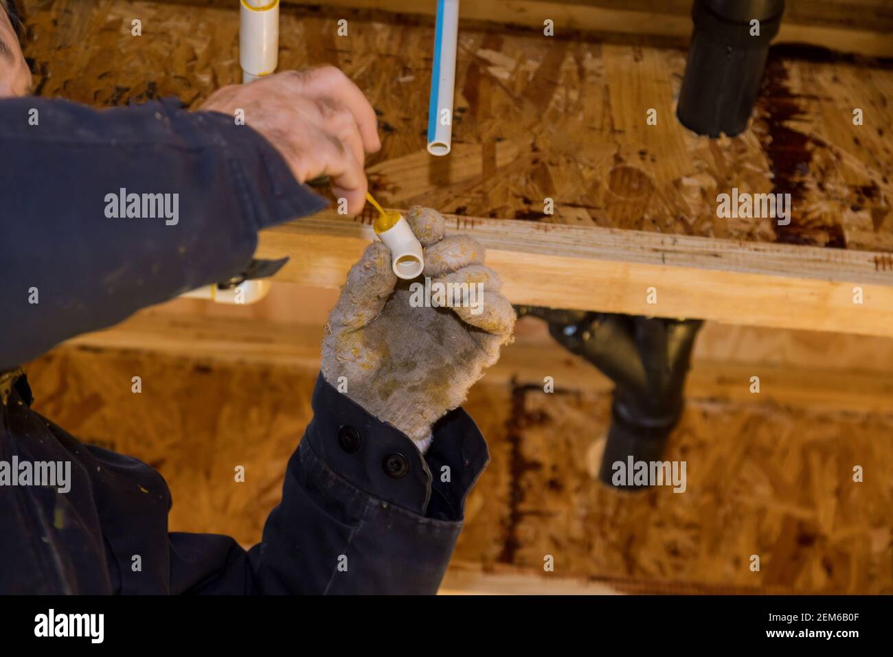 Gluing parts of a pvc water pipe using cement glue assembly