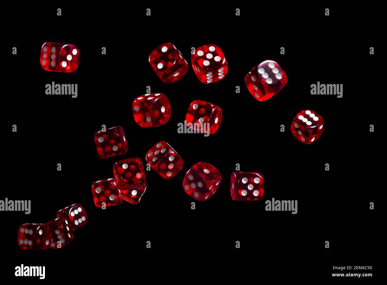 Many red dice flying on black background. Gambling concept. Stock Photo