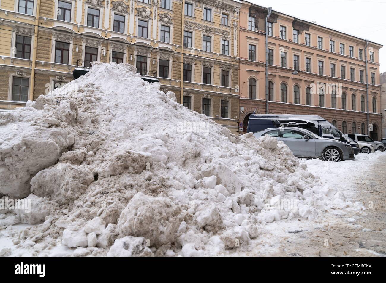 Pile snow with removed of after heavy snowfall on a city street. Winter