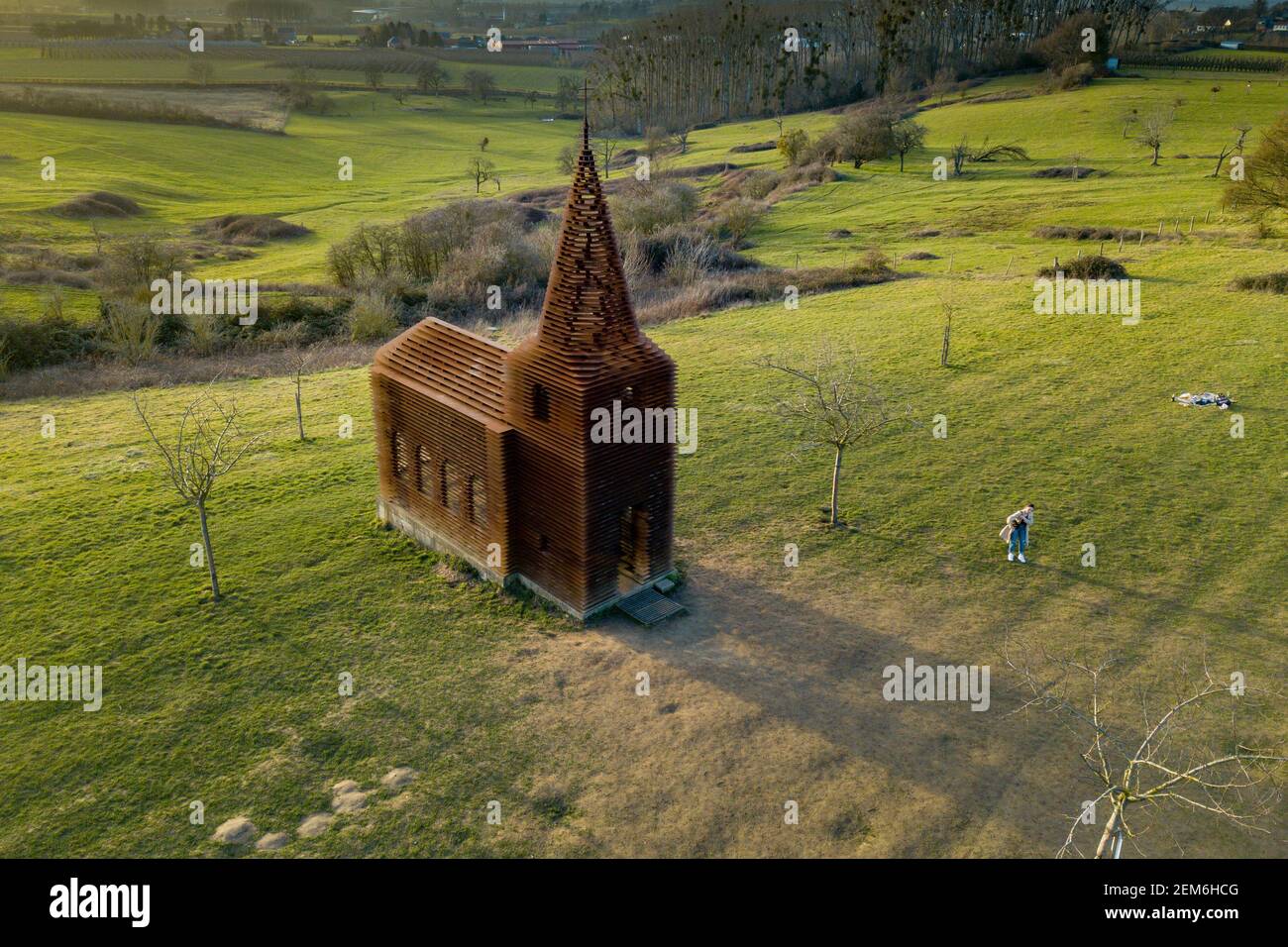 Brussels. 24th Feb, 2021. Aerial photo taken on Feb. 24, 2021 shows a 'see-through church,' a site-specific work entitled 'reading between the lines' outside the town of Borgloon, Belgium. Completed in 2011 by the Belgian architects duo Gijs Van Vaerenbergh, the project is 10 meters high and is made of 100 layers and 2000 columns of steel. Credit: Zhang Cheng/Xinhua/Alamy Live News Stock Photo