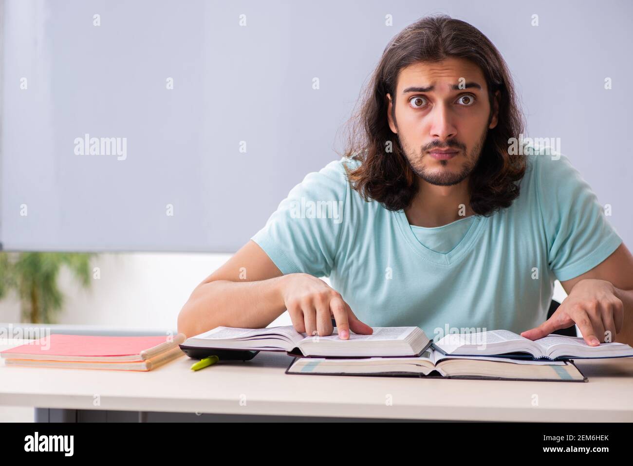 Young student preparing for exams in the classroom Stock Photo - Alamy