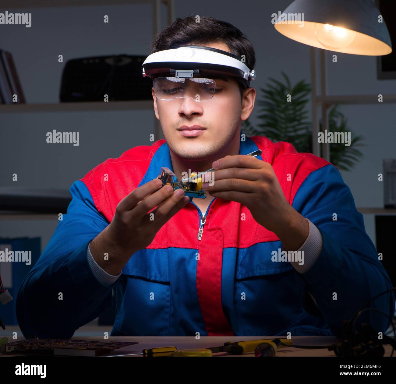 The computer specialist repairing pc late at night Stock Photo - Alamy