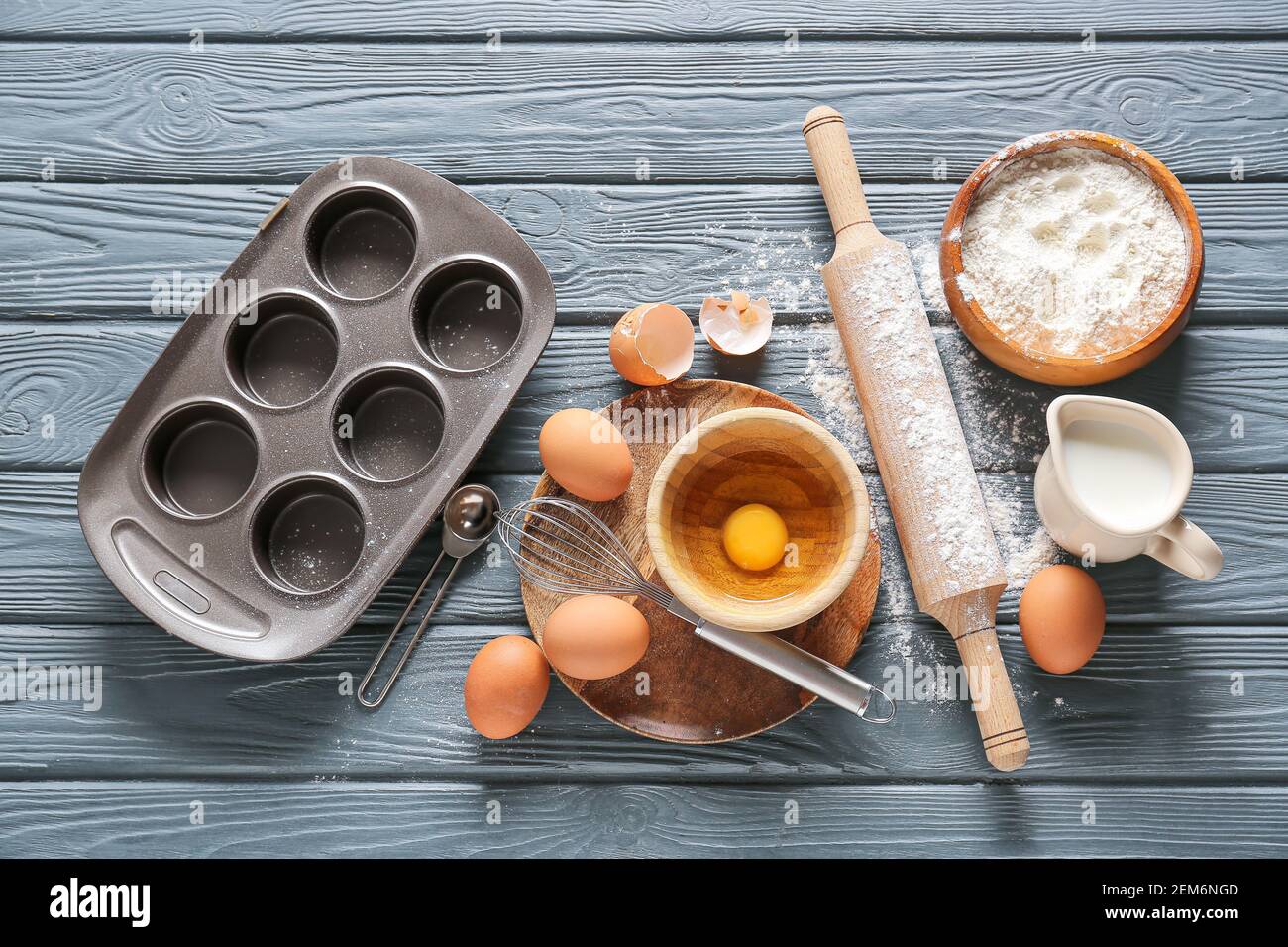Set of kitchen utensils and ingredients for preparing bakery on dark