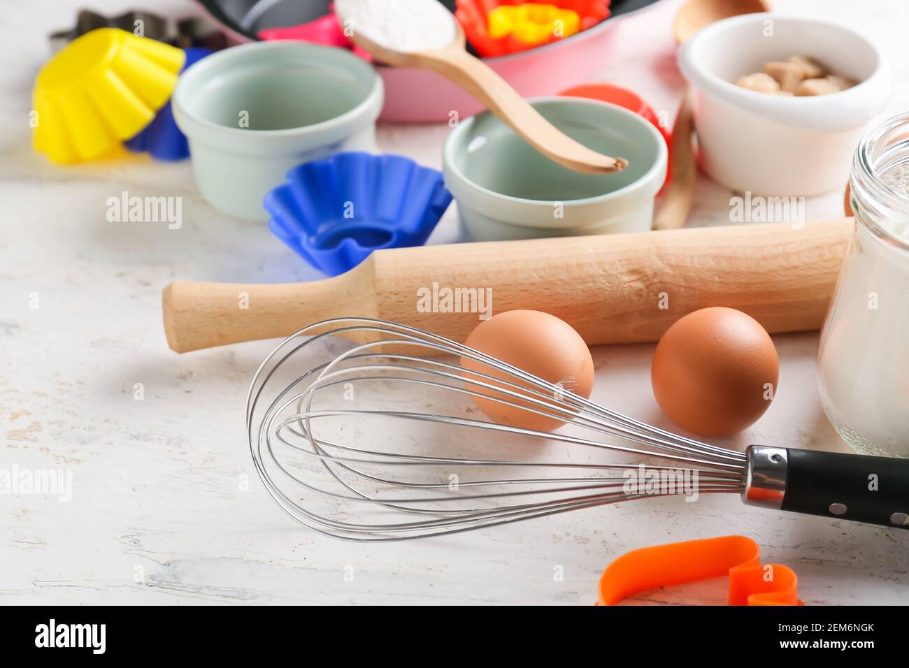 Set of kitchen utensils and ingredients for bakery on light background