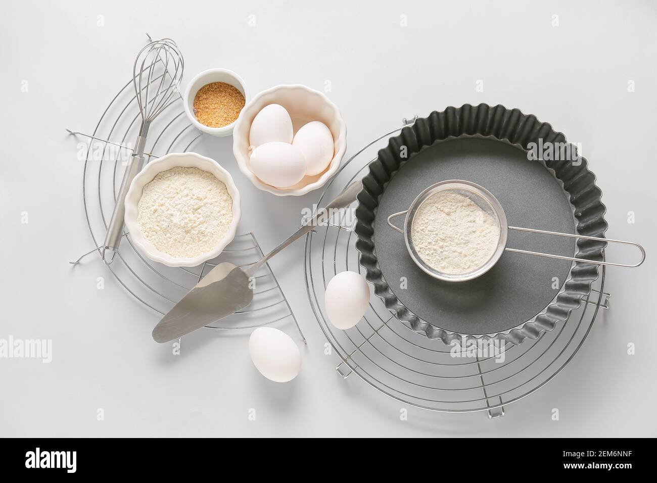 Set of kitchen utensils and ingredients for preparing bakery on light