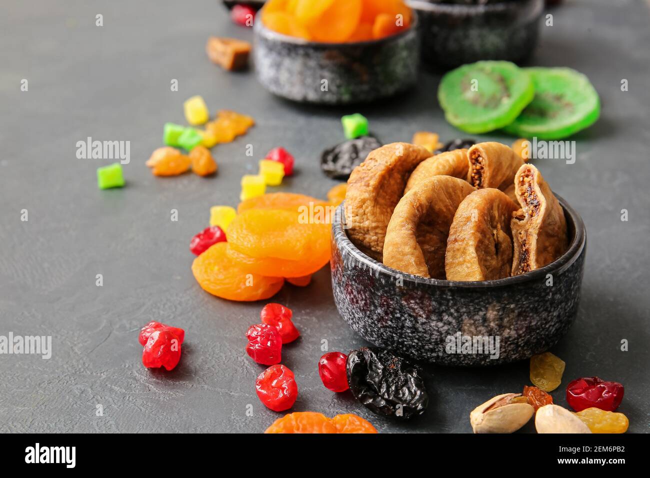 Bowls with dried figs on dark background Stock Photo
