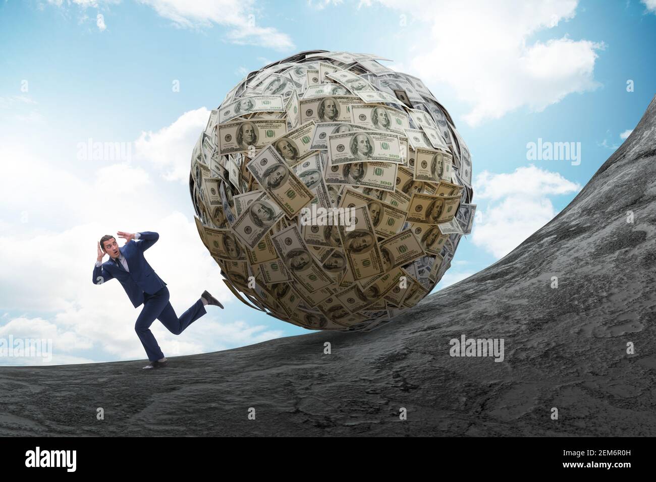 Businessman running away from the dollar ball Stock Photo - Alamy