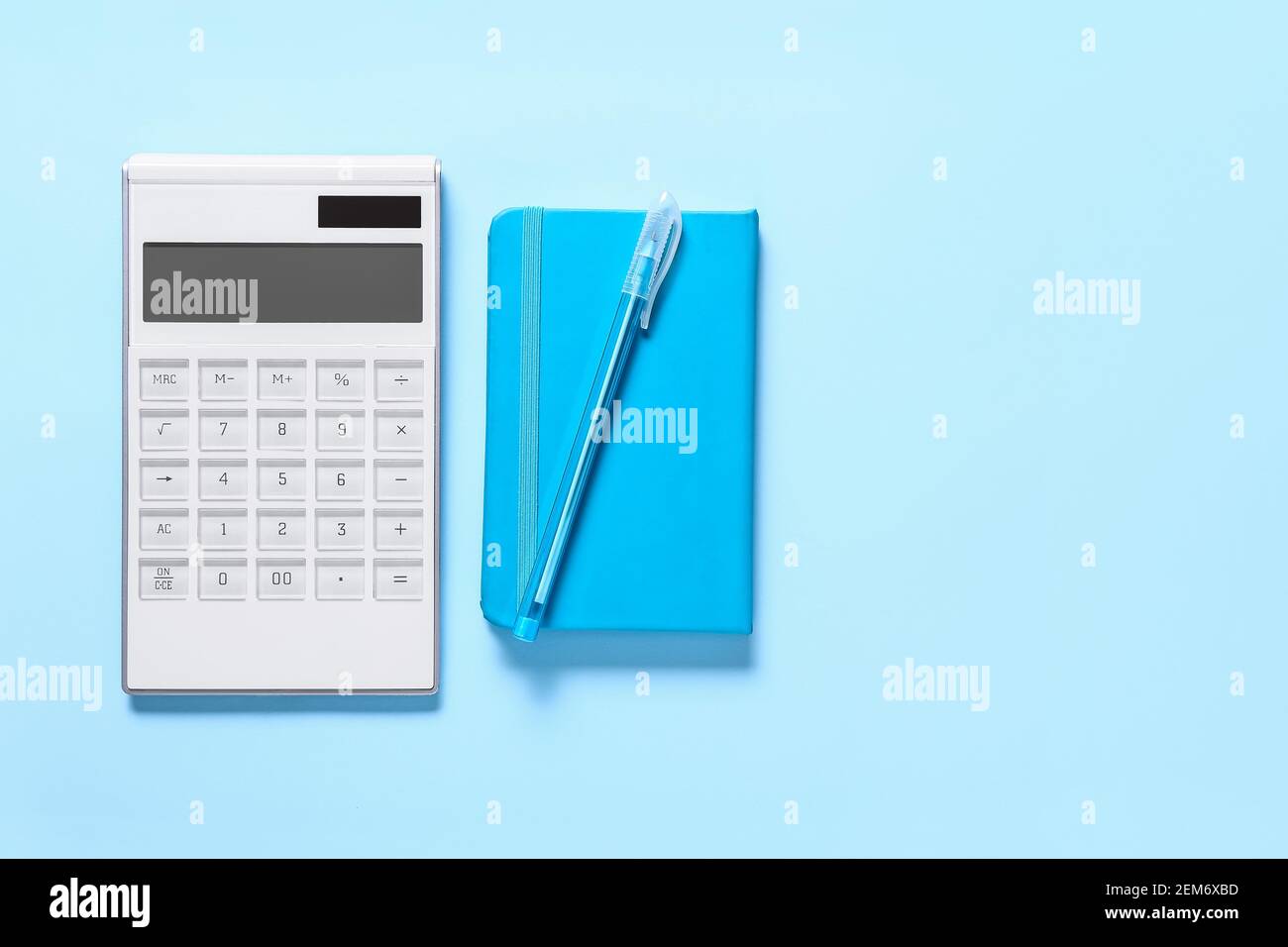 Modern calculator, pen and notebook on color background Stock Photo - Alamy