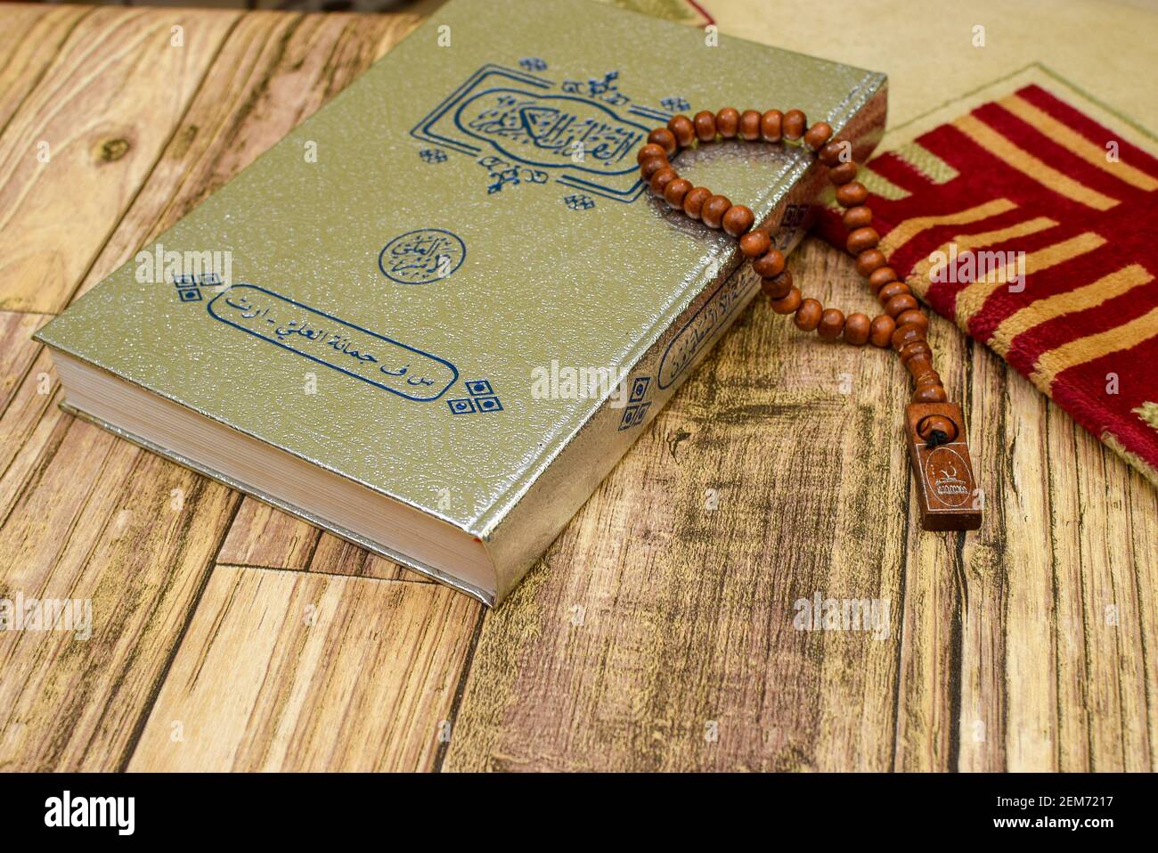 Al Quran and prayer beads and rug Stock Photo