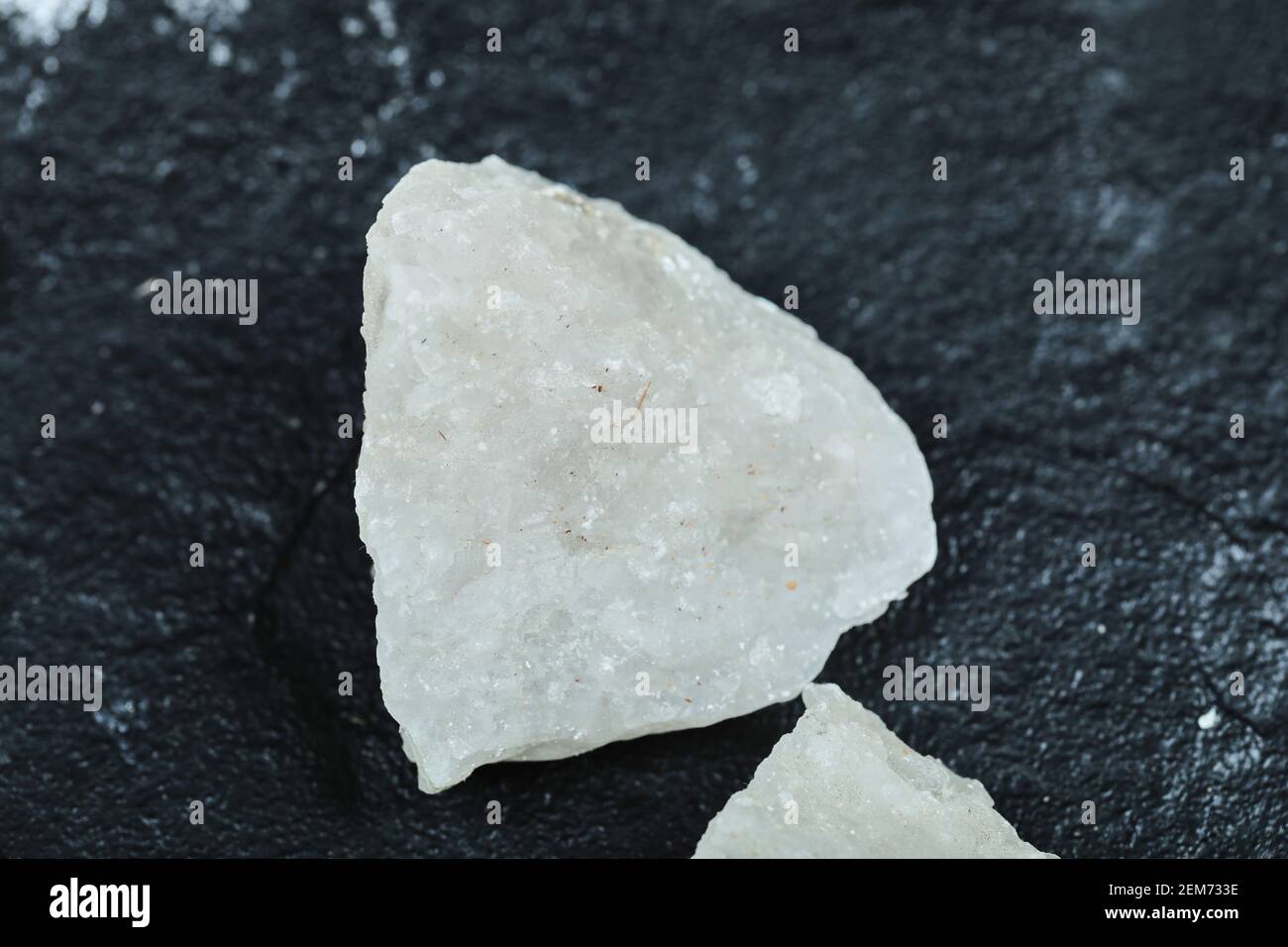 Crystalized salt rocks on dark background. Close up Stock Photo