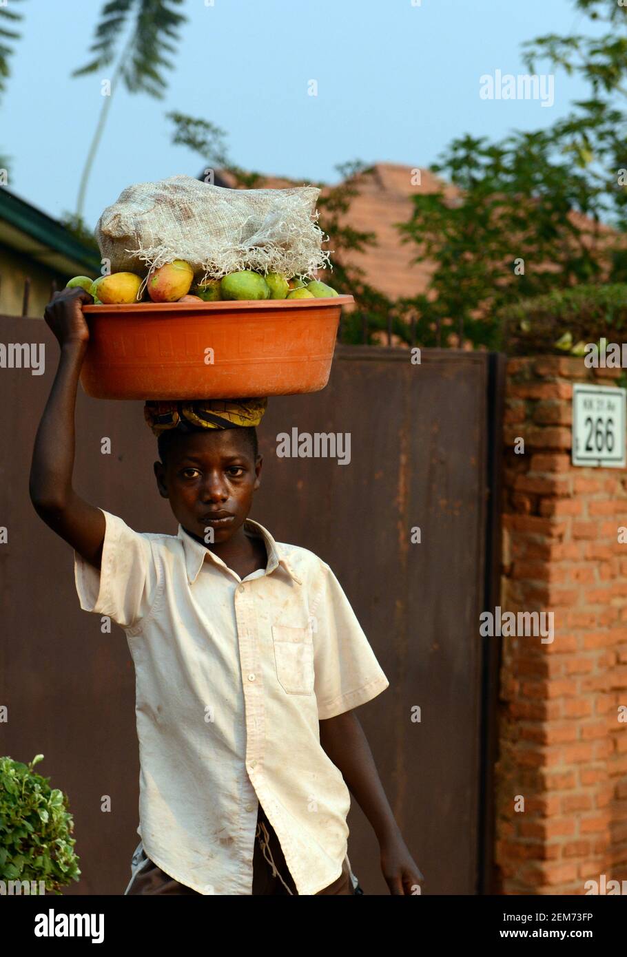 A Rwandan boy selling mangoes Stock Photo - Alamy