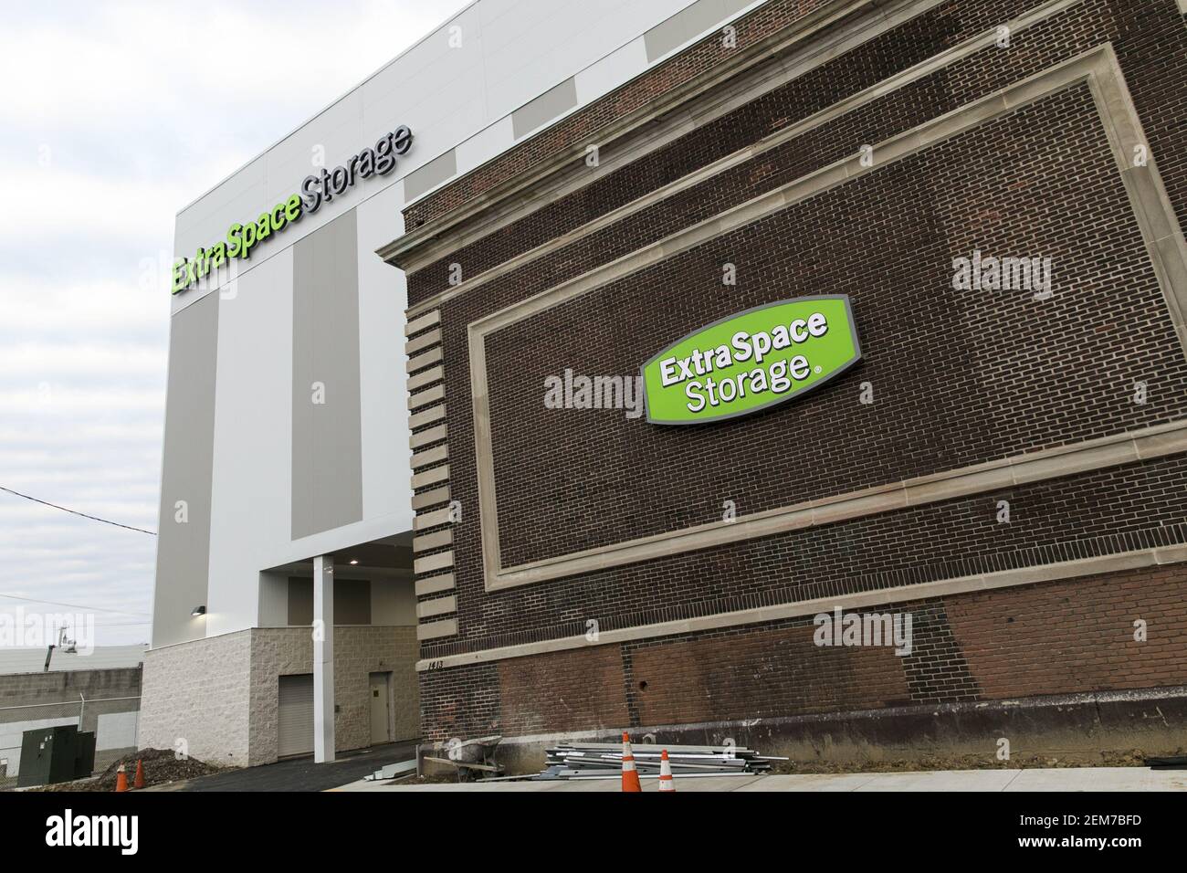 A logo sign outside of a facility occupied by Extra Space Storage in ...