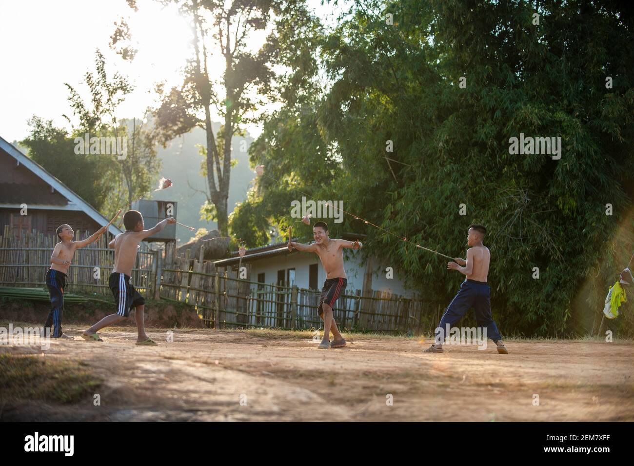Chiang Mai / Thailand - 16 Jan 2016: A group of boys play top for fun. Spinning tops are a kind of Thai play. In the evenings in the countryside in no Stock Photo