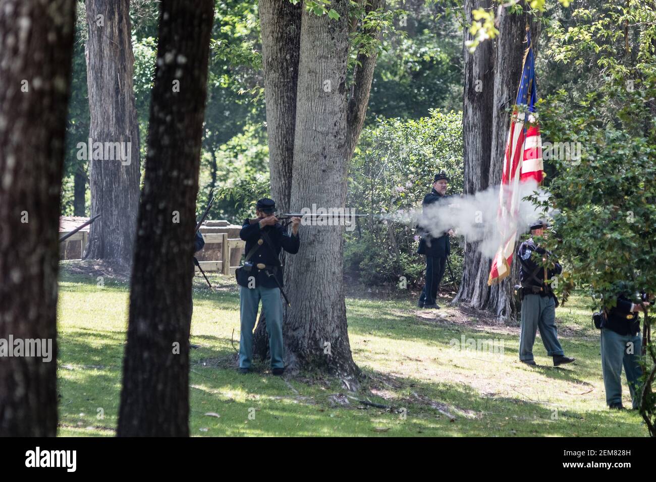 Marbury, Alabama/USA-April 28, 2018: Union soldiers take cover behind trees in the battle reenactment at the Confederate Memorial Park. Stock Photo