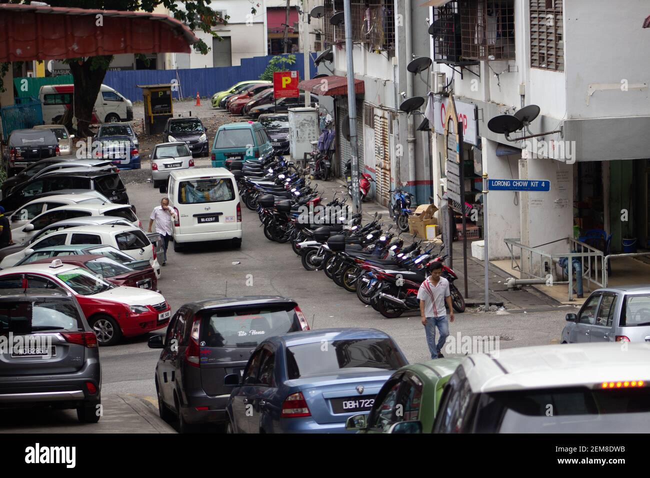 KUALA LUMPUR, MALASIA – JANUARY 27, 2020    crowded street with parked bike and cars Stock Photo