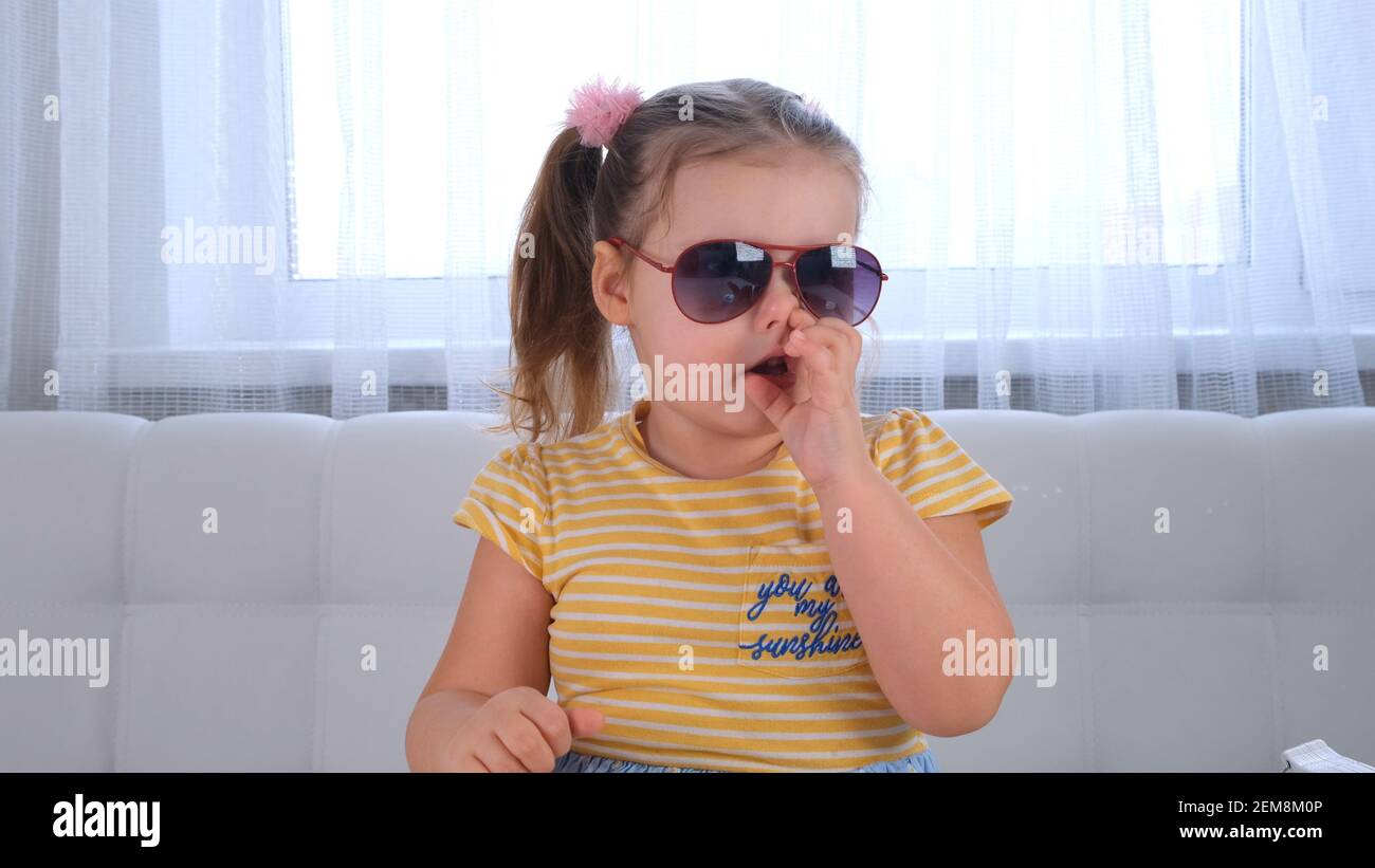 Cute little baby girl picking her nose close up. Stock Photo