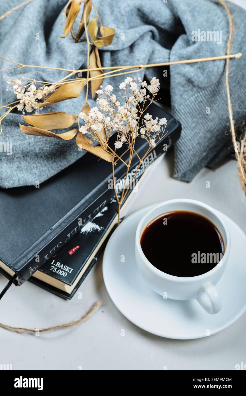 Cup of coffee with books under blue cloth Stock Photo